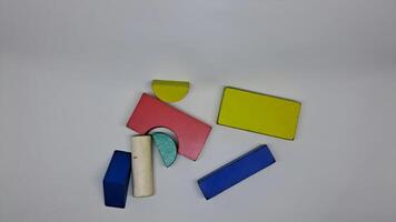 a group of colorful blocks on a white surface photo