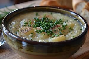 A bowl of Cullen skink, a Scottish smoked haddock soup, garnished with chopped chives. photo