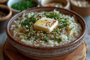 A bowl of kasha, a traditional buckwheat porridge, garnished with a pat of butter and a sprinkle of salt. photo