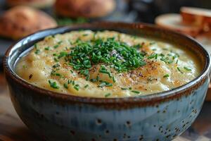 A bowl of Cullen skink, a Scottish smoked haddock soup, garnished with chopped chives. photo