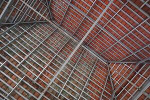 Roof construction photographed from below, composed of tiles and hollow iron photo