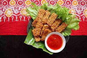 Tempeh Tempe Goreng or Fried tempeh is Indonesia traditional food, made from fermented soybean seeds photo