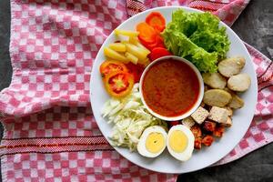 Gado-gado is a traditional Indonesian salad consisting of vegetables, potatoes, tempeh, tofu, carrots, tomatoes, lettuce, eggs and peanut sauce. Salad photo
