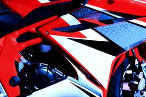 Racing motorcycle wrap red black. Custom illustrated vehicle stripe decal design kit for sides motorcycle, Sharp pointy geometric wing design. photo