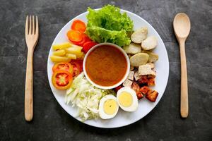 Gado-gado is a traditional Indonesian salad consisting of vegetables, potatoes, tempeh, tofu, carrots, tomatoes, lettuce, eggs and peanut sauce. Salad photo