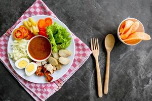 Gado-gado is a traditional Indonesian salad consisting of vegetables, potatoes, tempeh, tofu, carrots, tomatoes, lettuce, eggs and peanut sauce. Salad photo