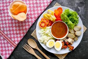 Gado-gado is a traditional Indonesian salad consisting of vegetables, potatoes, tempeh, tofu, carrots, tomatoes, lettuce, eggs and peanut sauce. Salad photo