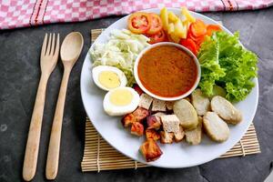 Gado-gado is a traditional Indonesian salad consisting of vegetables, potatoes, tempeh, tofu, carrots, tomatoes, lettuce, eggs and peanut sauce. Salad photo