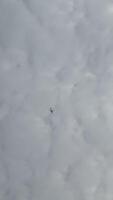 airplane in the cloudy sky, view from the ground, background photo