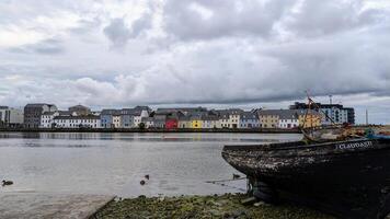 Cloudy Evening cityscape scenery, colourful houses at Long walk, Claddagh by Corrib river at Galway city, Ireland photo