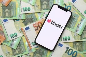 KYIV, UKRAINE - FEBRUARY 23, 2024 Tinder logo of famous dating website or app on iPhone display photo