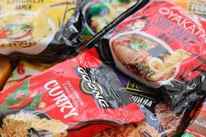 KYIV, UKRAINE - OCTOBER 31, 2023 Many packs of instant noodles for fast cooking by various brands and manufacturers photo