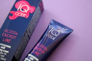 KYIV, UKRAINE - OCTOBER 31, 2023 Tube of IQ Code Gloss and Energy Line colorizer cream for hair photo