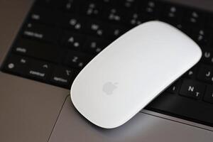 KYIV, UKRAINE - NOVEMBER 27, 2023 Apple Magic Mouse 3rd generation lies with grey MacBook 2021 photo