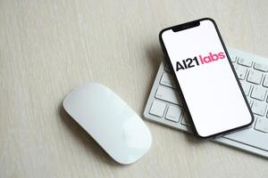 KYIV, UKRAINE - MARCH 17, 2024 AI21labs logo on iPhone display screen with apple keyboard and mouse on table photo