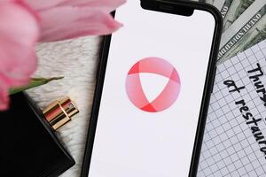 KYIV, UKRAINE - FEBRUARY 23, 2024 Open logo of famous dating website or app on iPhone display photo
