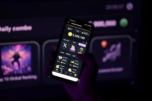 KYIV, UKRAINE - APRIL 20, 2024 Hamster Kombat telegram bot on smartphone screen. Hamster Kombat is a viral Telegram-based crypto game for earn HMSTR tokens by managing virtual crypto exchange photo