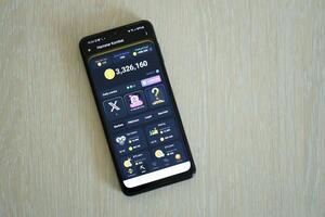 KYIV, UKRAINE - APRIL 20, 2024 Hamster Kombat telegram bot on smartphone screen. Hamster Kombat is a viral Telegram crypto game for earn HMSTR tokens by managing virtual crypto exchange photo