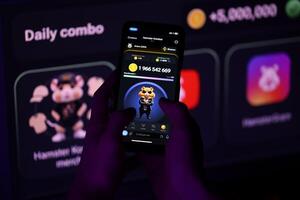 KYIV, UKRAINE - APRIL 20, 2024 Hamster Kombat telegram bot on smartphone screen. Hamster Kombat is a viral Telegram-based crypto game for earn HMSTR tokens by managing virtual crypto exchange photo