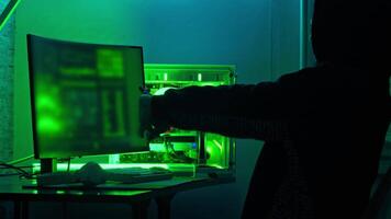 Hacker prepares for hacking by stretching while sitting in his lair. Close up. Slow motion. video