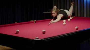 Professional billiards player accurately shoots a ball into the distant pocket, leaning on the table. video