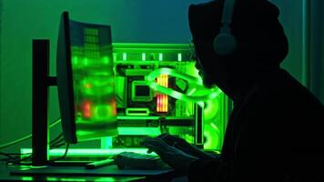 Hacker commits a cyberattack from his hiding place. He types a code on the keyboard. Close up. Slow motion. video