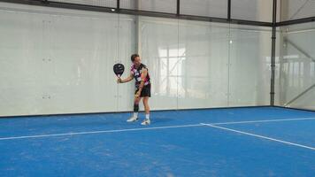 Boy Makes Serve In Indoor Padel Court With Racket video