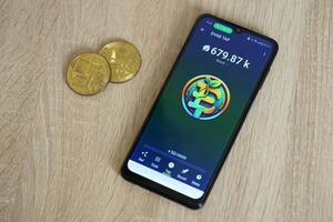 KYIV, UKRAINE - APRIL 20, 2024 EVAB TAP telegram bot on smartphone screen. EVAB TAP is a viral Telegram based crypto game for earn tokens by managing virtual crypto exchange photo