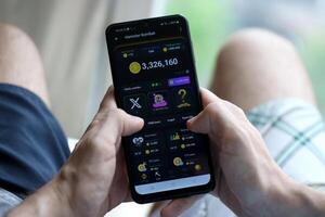 KYIV, UKRAINE - APRIL 20, 2024 Hamster Kombat telegram bot on smartphone screen. Hamster Kombat is a viral Telegram crypto game for earn HMSTR tokens by managing virtual crypto exchange photo