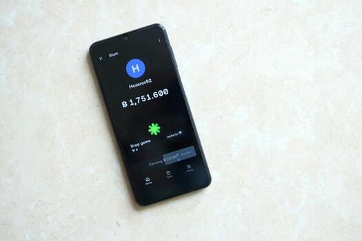 KYIV, UKRAINE - APRIL 20, 2024 Blum telegram bot on smartphone screen. Blum is a viral Telegram based crypto game for earn tokens by managing virtual crypto exchange photo