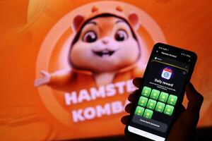 KYIV, UKRAINE - APRIL 20, 2024 Hamster Kombat telegram bot on smartphone screen. Hamster Kombat is a viral Telegram-based crypto game for earn HMSTR tokens by managing virtual crypto exchange photo
