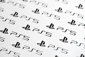 KYIV, UKRAINE - JUNE 26, 2024 Sony Playstation 5 console logo repeating many times on white paper background banner photo