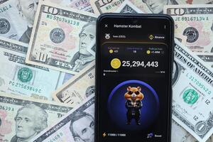 KYIV, UKRAINE - JUNE 20, 2024 Hamster Kombat tap 2 earn mini game in telegram messenger on smartphone display photo