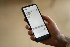 KYIV, UKRAINE - JUNE 20, 2024 Hand holds smartphone with Rezerv plus - ukrainian application for smartphone with actual personal information about conscript status photo