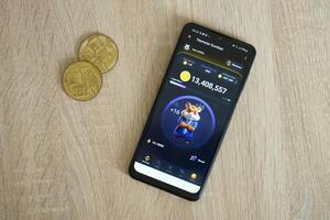 KYIV, UKRAINE - APRIL 20, 2024 Hamster Kombat telegram bot on smartphone screen. Hamster Kombat is a viral Telegram crypto game for earn HMSTR tokens by managing virtual crypto exchange photo