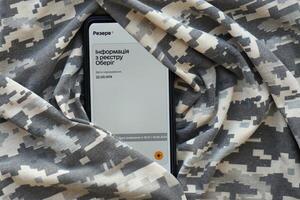 KYIV, UKRAINE - JUNE 20, 2024 Rezerv plus - ukrainian application for smartphone with actual personal information about conscript status for military recruits photo