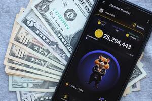 KYIV, UKRAINE - JUNE 20, 2024 Hamster Kombat tap 2 earn mini game in telegram messenger on smartphone display photo