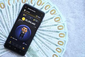 KYIV, UKRAINE - JUNE 20, 2024 Hamster Kombat tap 2 earn mini game in telegram messenger on smartphone display photo