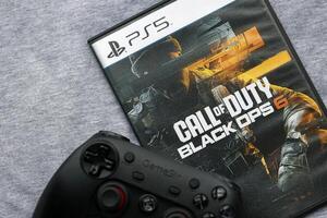 KYIV, UKRAINE - JUNE 26, 2024 Call of Duty Black Ops 6 PS5 game disc box for console gaming. Popular game disc photo
