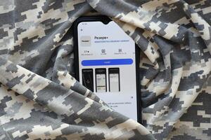 KYIV, UKRAINE - JUNE 20, 2024 Rezerv plus - ukrainian application for smartphone with actual personal information about conscript status for military recruits photo
