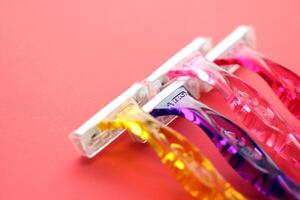 KYIV, UKRAINE - JUNE 26, 2024 Bic Miss Soleil colour collection safety blade razor for shaving on paper background photo