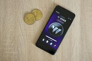 KYIV, UKRAINE - APRIL 20, 2024 W-coin telegram bot on smartphone screen. W-coin is a viral Telegram based crypto game for earn tokens by managing virtual crypto exchange photo