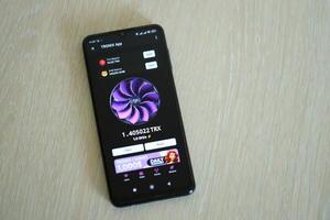 KYIV, UKRAINE - APRIL 20, 2024 Tronix App telegram bot on smartphone screen. Tronix App is a viral Telegram based crypto game for earn TRX tokens by managing virtual crypto exchange photo