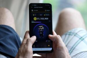 KYIV, UKRAINE - APRIL 20, 2024 Hamster Kombat telegram bot on smartphone screen. Hamster Kombat is a viral Telegram crypto game for earn HMSTR tokens by managing virtual crypto exchange photo