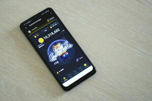 KYIV, UKRAINE - APRIL 20, 2024 Hamster Kombat telegram bot on smartphone screen. Hamster Kombat is a viral Telegram crypto game for earn HMSTR tokens by managing virtual crypto exchange photo
