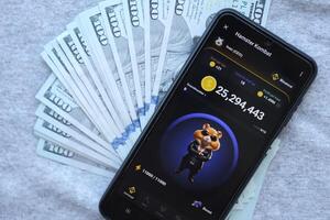 KYIV, UKRAINE - JUNE 20, 2024 Hamster Kombat tap 2 earn mini game in telegram messenger on smartphone display photo