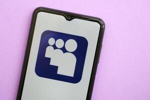 KYIV, UKRAINE - APRIL 1, 2024 Myspace icon on smartphone screen on purple table photo