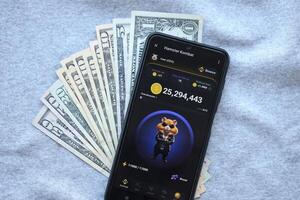 KYIV, UKRAINE - JUNE 20, 2024 Hamster Kombat tap 2 earn mini game in telegram messenger on smartphone display photo