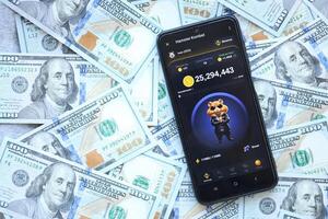 KYIV, UKRAINE - JUNE 20, 2024 Hamster Kombat tap 2 earn mini game in telegram messenger on smartphone display photo