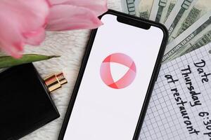 KYIV, UKRAINE - FEBRUARY 23, 2024 Open logo of famous dating website or app on iPhone display photo